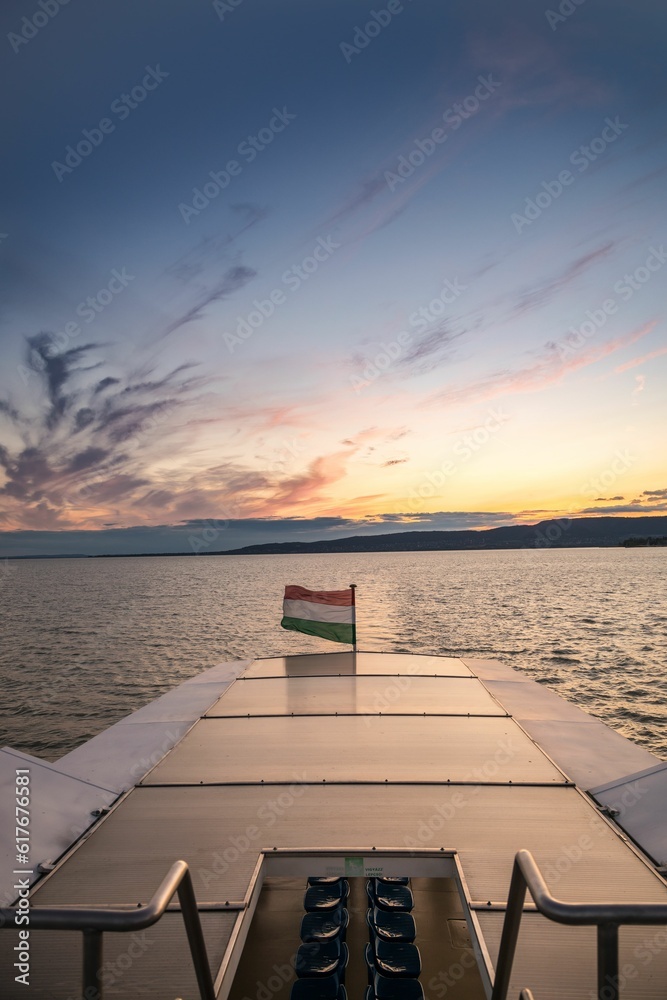 Ship cruising at Balaton lake, Hungary in the summer sunset.