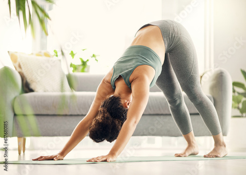 Slika na platnu Yoga, woman and zen at home with downward dog pose and meditation feeling calm on gym mat
