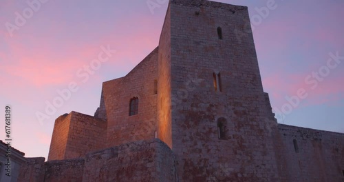 Low angle shot of Peniscola castle, residence of the Antipope Benedict XIII in Peniscola, Castellon, Spain during evening time. Colorful sky. photo