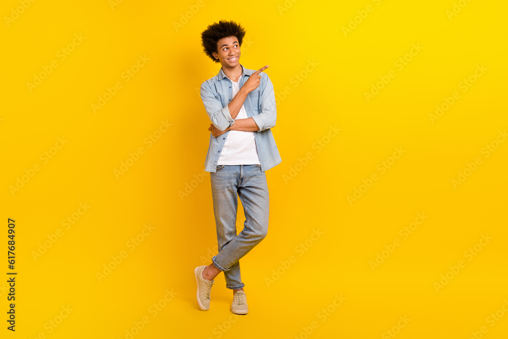 Fototapeta premium Full body photo of positive person look direct finger empty space proposition isolated on yellow color background