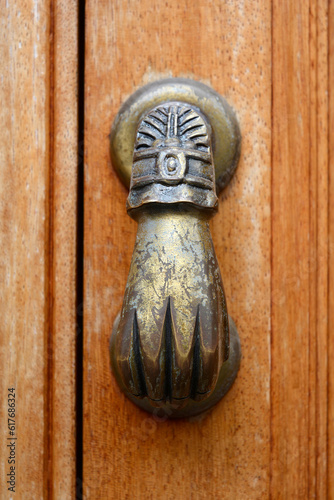 Brass hand door knocker