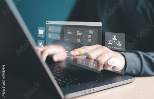 Man using laptop computer to manage files on company server. Cloud backup online documentation and digital file storage software, records tracking app, Database download, upload and Permission access.