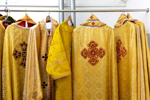 Liturgical clothes, liturgical vestments, robes, hanging on hangers. photo