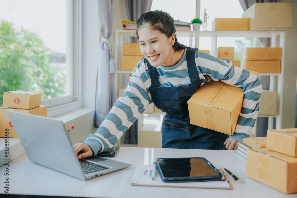 Happy Asian woman working in SME and using smartphone to receive orders via online email, message in chat box, SME seller concept, ecommerce team, online sales. Happy Asian woman working in SME and using smartphone to receive orders via online email, message in chat box, SME seller concept, ecommerce team, online sales.