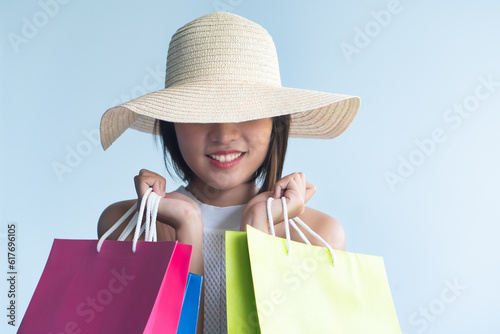 Fotografie Stylish happy smiling anonymous young Asian woman in urban shopping adventure on