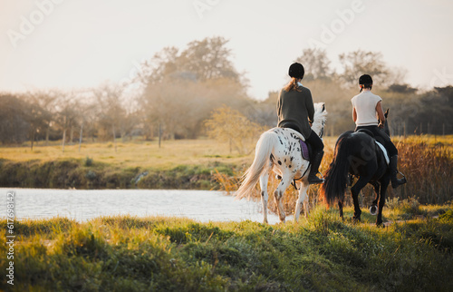Horseback riding, freedom and friends in nature by the lake during a summer morning with a view. Countryside, equestrian and female riders bonding outdoor together for wilderness travel or adventure