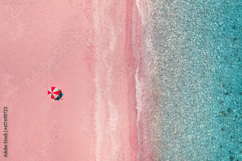 Fototapeta Naklejka Na Ścianę i Meble -  Umbrella on pink beach by sea