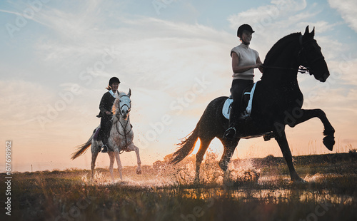 Sunset, girl and horse riding in water for adventure in nature for fun on weekend with friends. Vacation, riders and animal with woman or equestrian with running in outdoor or field, summer or race.