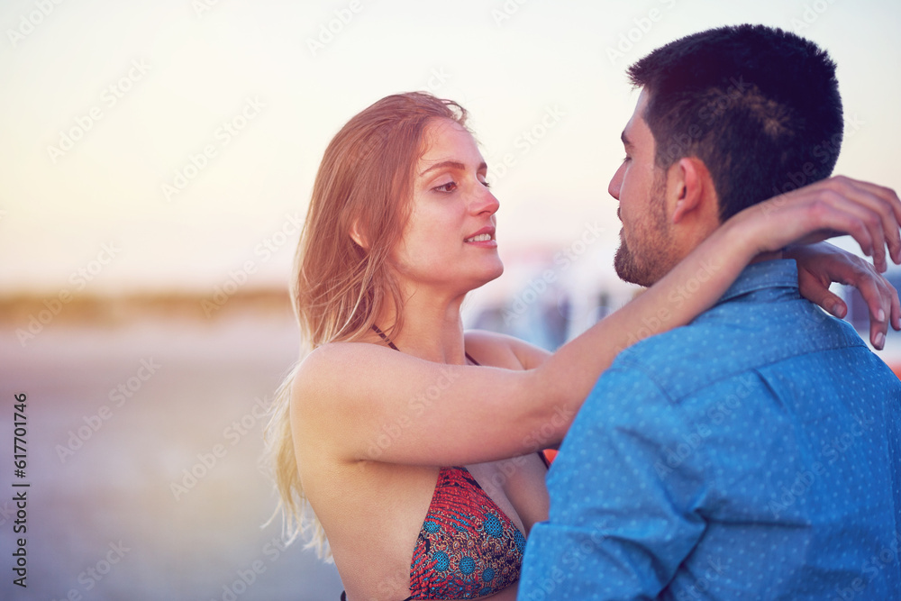 Fototapeta premium Couple, vacation and hug outdoor with love at the beach for travel, freedom and romantic date. Young woman and a man together on holiday to relax, bond and quality time with affection in nature