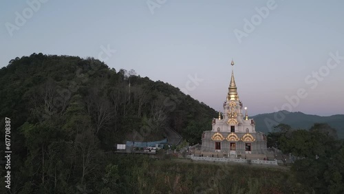 4k Drone Orbiting around Buddhist Temple in Mae Salong village at Sunrise. photo