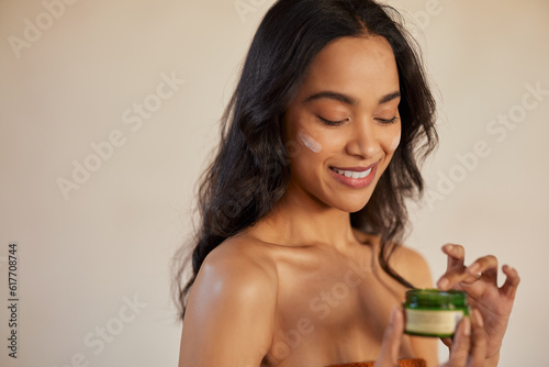 Woman applying bio organic face cream