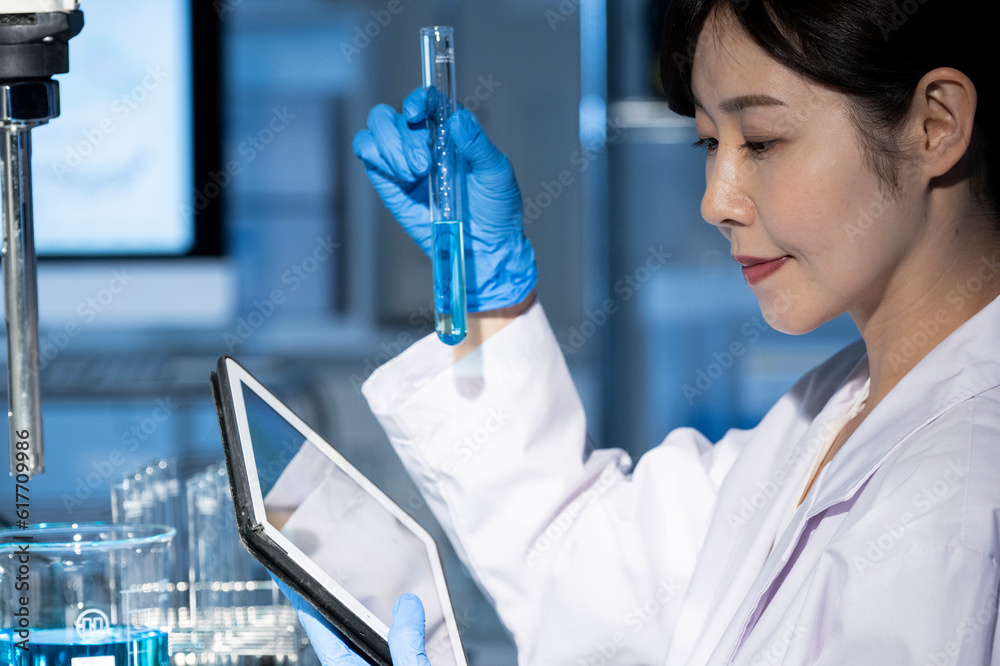 A female scientist conducting research with a test tube A female scientist conducting research with a test tube