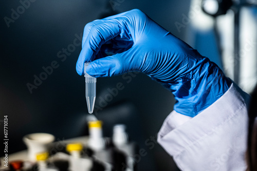 Close-up of a scientist's hand doing research with a centrifuge and its tube in a laboratory