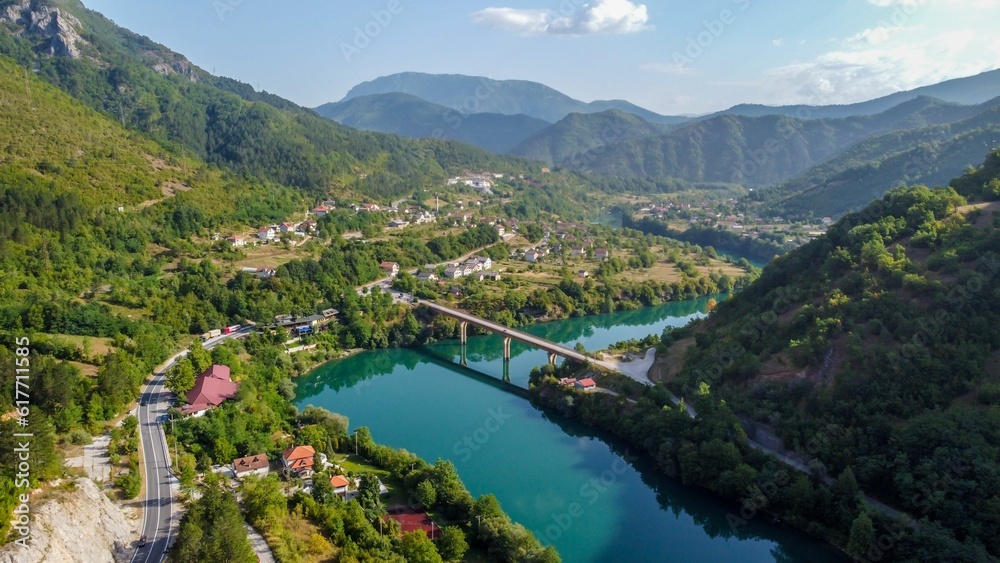 Scenic view of a road passing through a majestic gorge, with a bridge in the distance in Bosnia