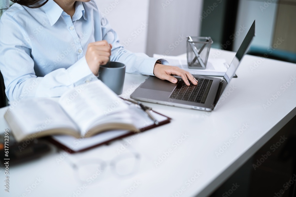 Asian Woman working by using a laptop computer Hands typing on keyboard. Working at office professional investor working new start up project Asian Woman working by using a laptop computer Hands typing on keyboard. Working at office professional investor working new start up project