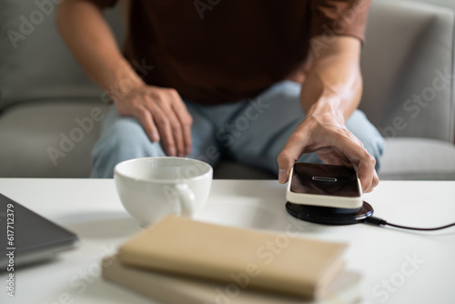 Man hands Charging mobile phone battery with low battery. plugging a charger in a smart phone   with energy bank powerbank charger Modern lifestyle energy technology