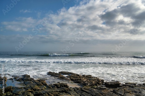 Beautiful view of a tranquil beach on a cloudy sky background photo