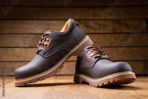 Stylish men's casual work boots for everyday walking in nature and the city on a wooden background stylish concept