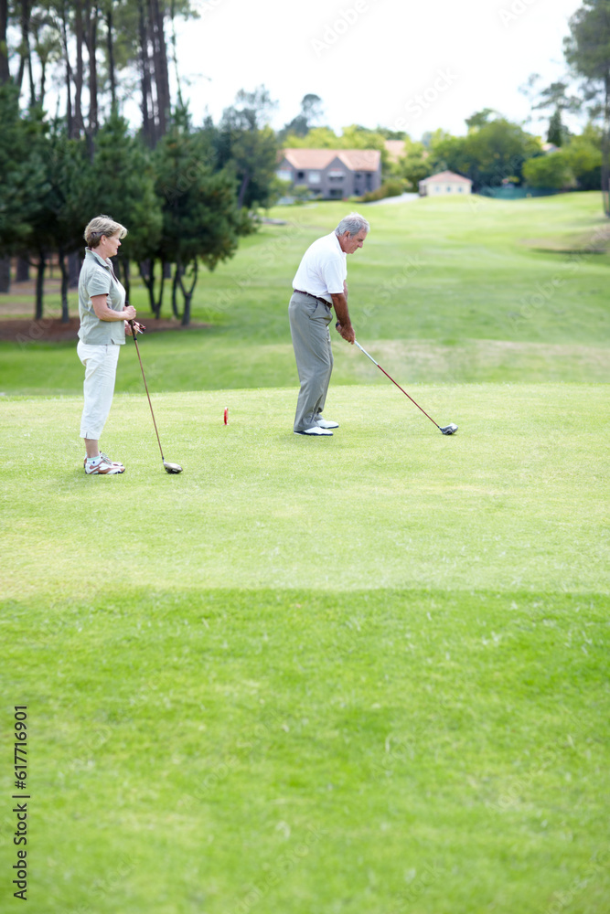 Obraz premium Old couple, sports or golfer playing golf for fitness, workout or exercise to swing on a course or field. Senior woman, elderly man golfing or training in practice game and driving with a club stroke