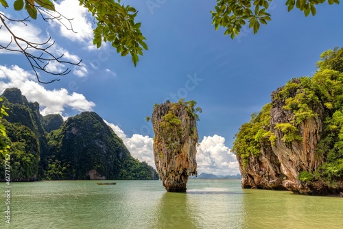 a large rock formation sits in a lagoon in thailand, surrounded by trees
