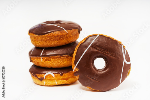 chocolate donuts on a white background. flour donuts with chocolate icing on a light background. colorful pastries