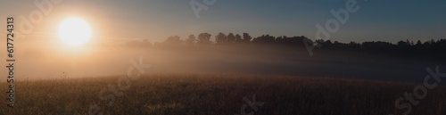 Panoramic shot of a cloudy sunset sky over a rural field near a park