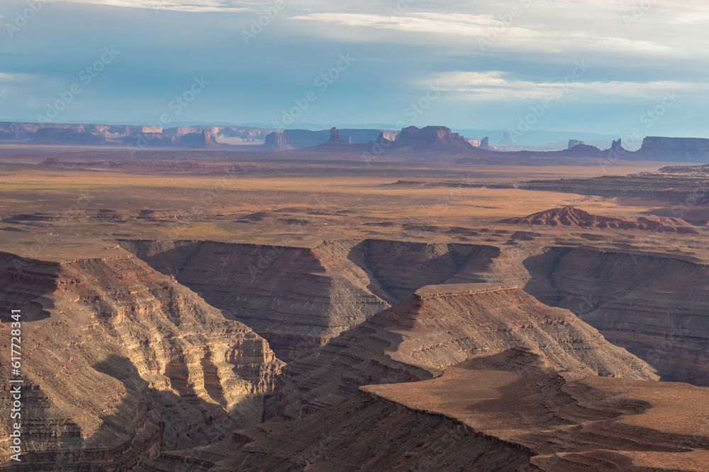 Fototapeta premium Scenic aerial vistas of desert landscape and canyons of Valley of the Gods seen from remote cliff Muley Point near Mexican Hat, San Juan county, Utah, USA. Monument valley seen in the distance