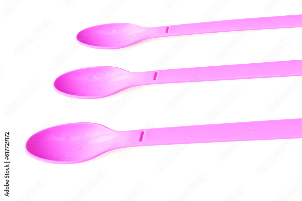 Pink plastic spoons for camping, isolated on white surface