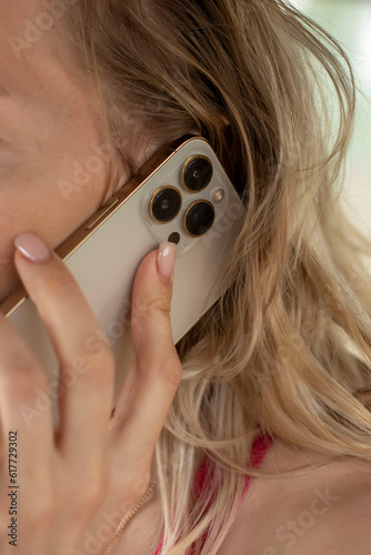the phone is in the girl's hands near her ear