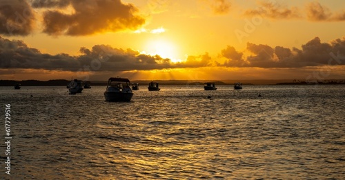 many boats are floating out on the water at sunset or in ocean