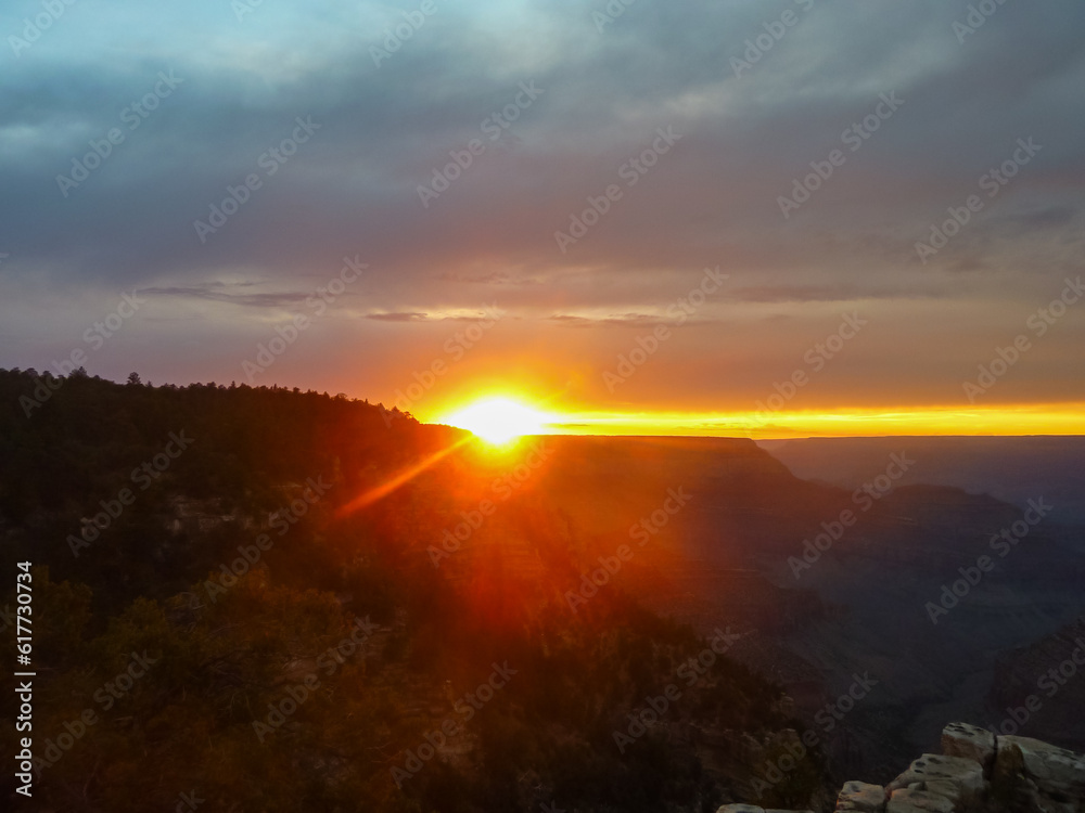 Silhouette view of the canyon mountain ridges during a romantic sunset at the South Rim, Grand Canyon National Park, Arizona, USA. Red orange sky creates mystical atmosphere