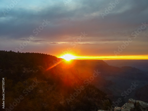 Silhouette view of the canyon mountain ridges during a romantic sunset at the South Rim, Grand Canyon National Park, Arizona, USA. Red orange sky creates mystical atmosphere