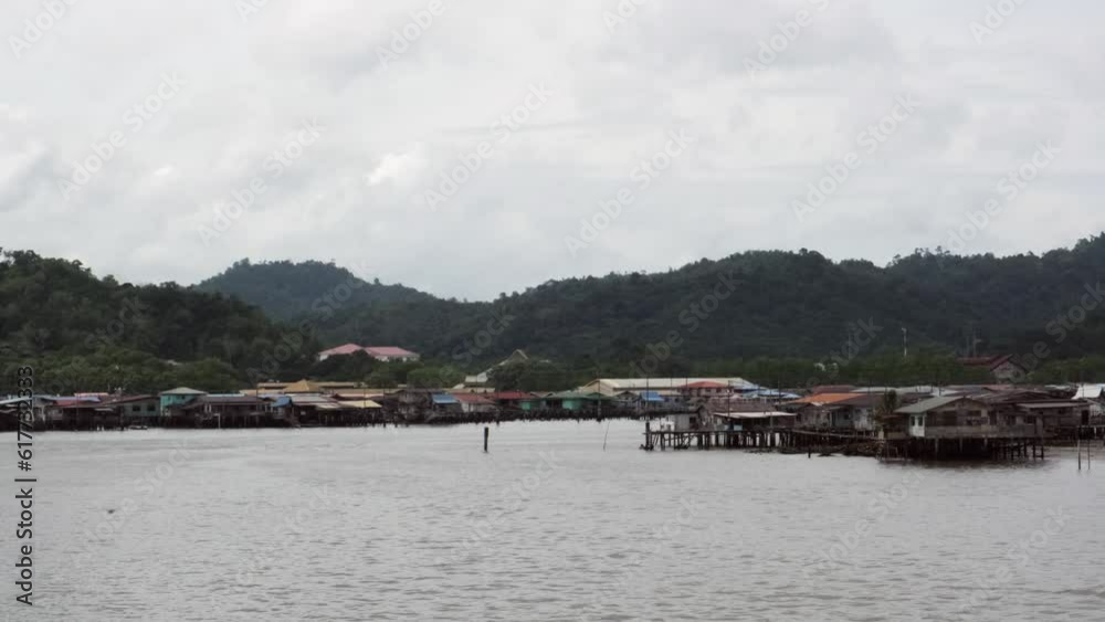 4K view of Kampong Ayer in Brunei with houses and green mountains with cloudy sky 4K view of Kampong Ayer in Brunei with houses and green mountains with cloudy sky