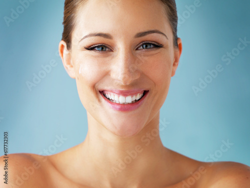 Skin care, cosmetics and smile, portrait of woman with dermatology and makeup on blue background. Happiness, skincare and wellness, happy face of model with beauty and facial glow on studio backdrop.