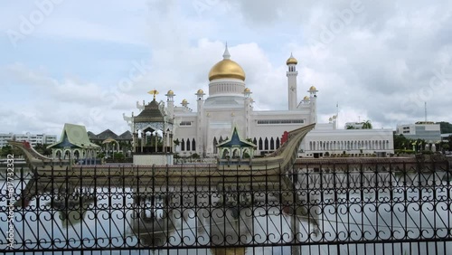 View of Omar Ali Saifuddien Mosque in Bandar Seri Begawan, Brunei by the water with cloudy sky photo