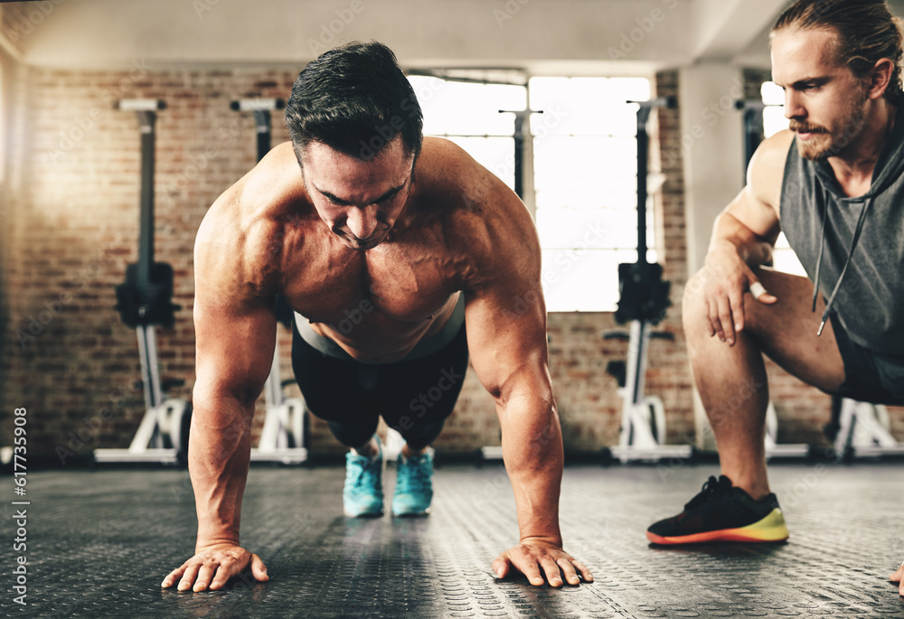 Push up, strong and man or personal trainer in gym support, motivation and helping body builder in training. Muscle, fitness and focus of people exercise or workout on floor, advice or accountability Push up, strong and man or personal trainer in gym support, motivation and helping body builder in training. Muscle, fitness and focus of people exercise or workout on floor, advice or accountability