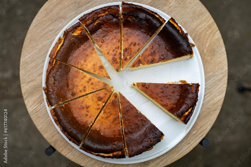 Fototapeta premium delicious, homemade cheesecake baked according to an old family recipe. The sight of the cheesecake is mouthwatering, with its golden crust and creamy, velvety texture