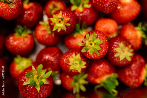 delightful sight of fresh, juicy strawberries. The vibrant red color of the strawberries is truly enticing, inviting us to indulge in their natural sweetness. The photograph seems to carry the scent o
