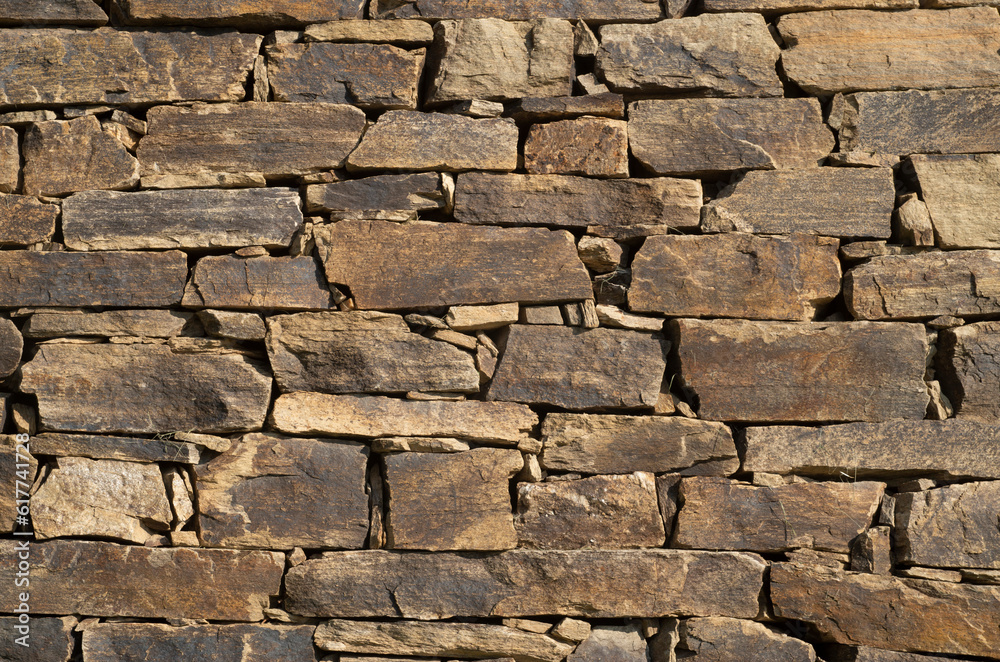 Fototapeta premium New brown stone wall close