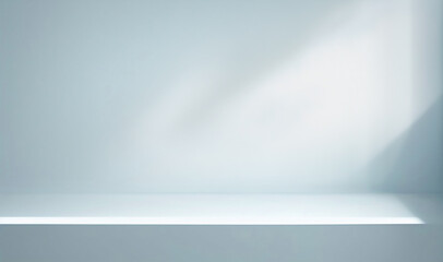 Minimal abstract light blue background for product presentation. Shadow and light from windows on plaster wall.
