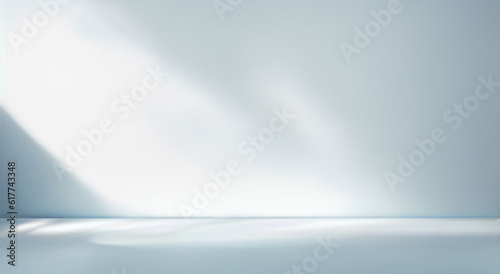 Minimal abstract light blue background for product presentation. Shadow and light from windows on plaster wall. © Laura Pashkevich