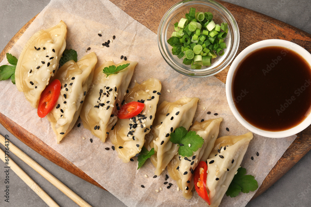 Delicious gyoza (asian dumplings) served on gray table, flat lay Delicious gyoza (asian dumplings) served on gray table, flat lay