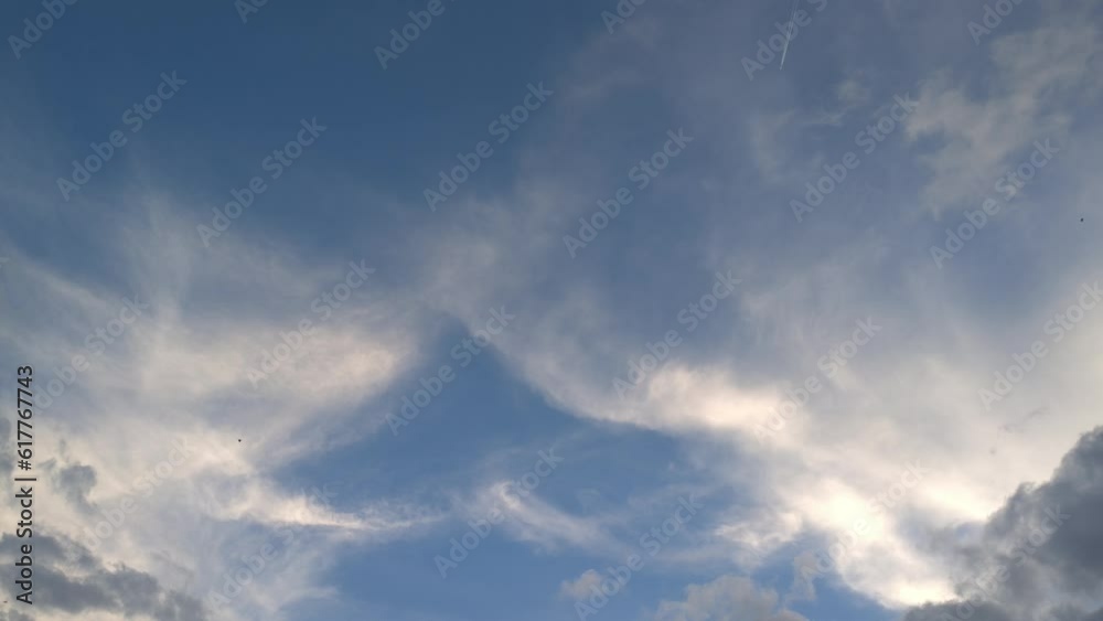 Blurred clouds that seem to have high fives at sunset while the birds fly Blurred clouds that seem to have high fives at sunset while the birds fly