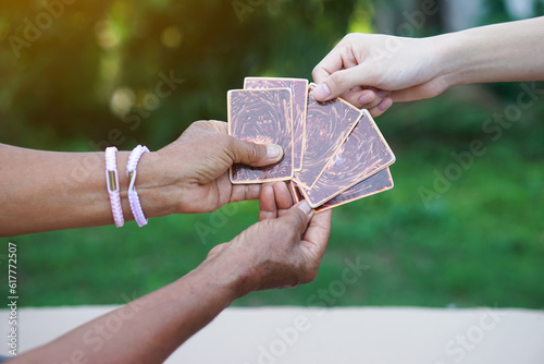 Close up hand chooses fortune paper cards from fortune teller. Concept, Fortune reading. astrology. Foretelling, mystery, magic, fortune, fate. Prediction for future life ,events.   