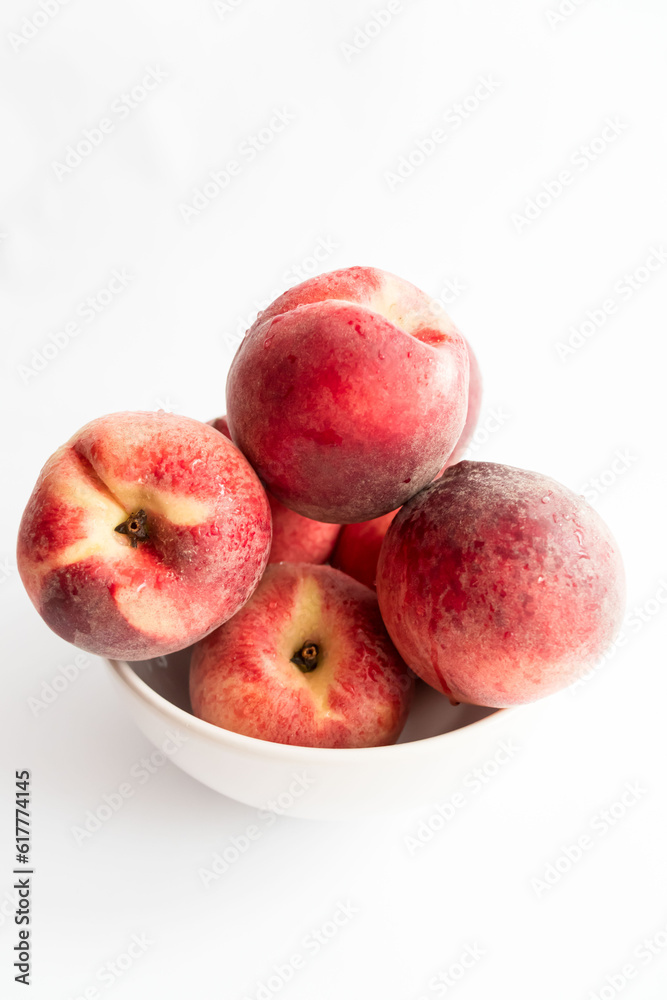 ripe peaches on a white background. top view. close up. fresh peaches in a bowl on a white background. ripe peaches on a white background. top view. close up. fresh peaches in a bowl on a white background.