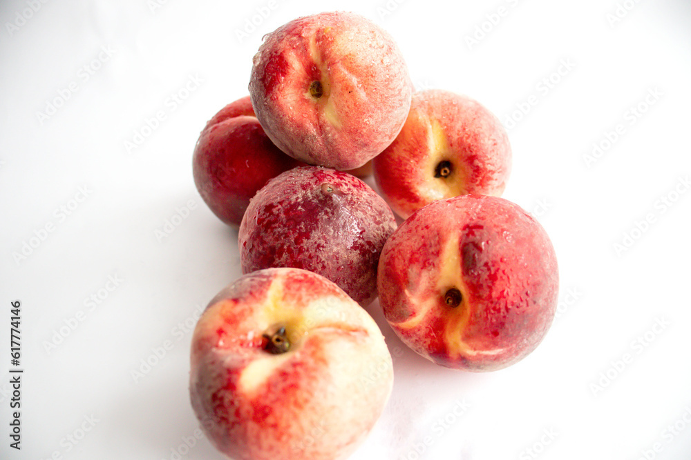 ripe peaches on a white background. top view. close up. fresh peaches in a bowl on a white background. ripe peaches on a white background. top view. close up. fresh peaches in a bowl on a white background.