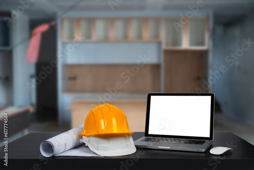 Construction house and building. Repair work. dof laptop computer and office construction on table in office blurred background.Architect concept.