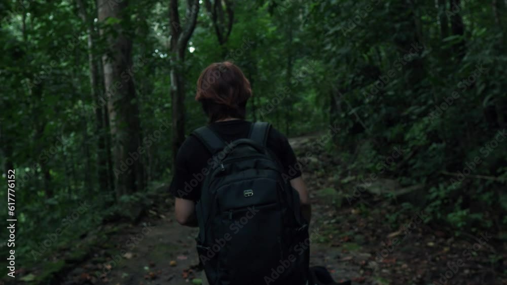 Female tourist climbing a rocky rugged forest trail. Yagirala Rain Forest. Female tourist climbing a rocky rugged forest trail. Yagirala Rain Forest.