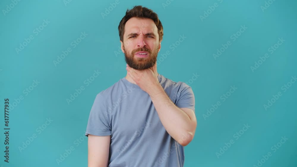 Bearded sick man feels sore throat and blows nose frowning Bearded sick man feels sore throat and blows nose frowning