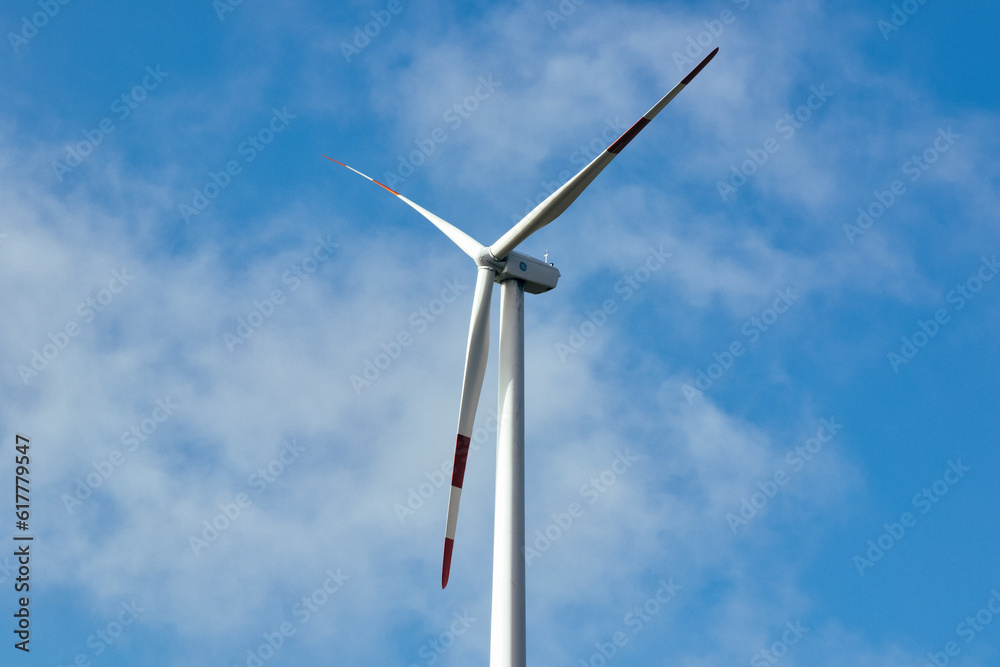 a wind farm full of turbines in the Italian mountains. The green economy and technology are the only solution to protect the planet from climate change and global warming